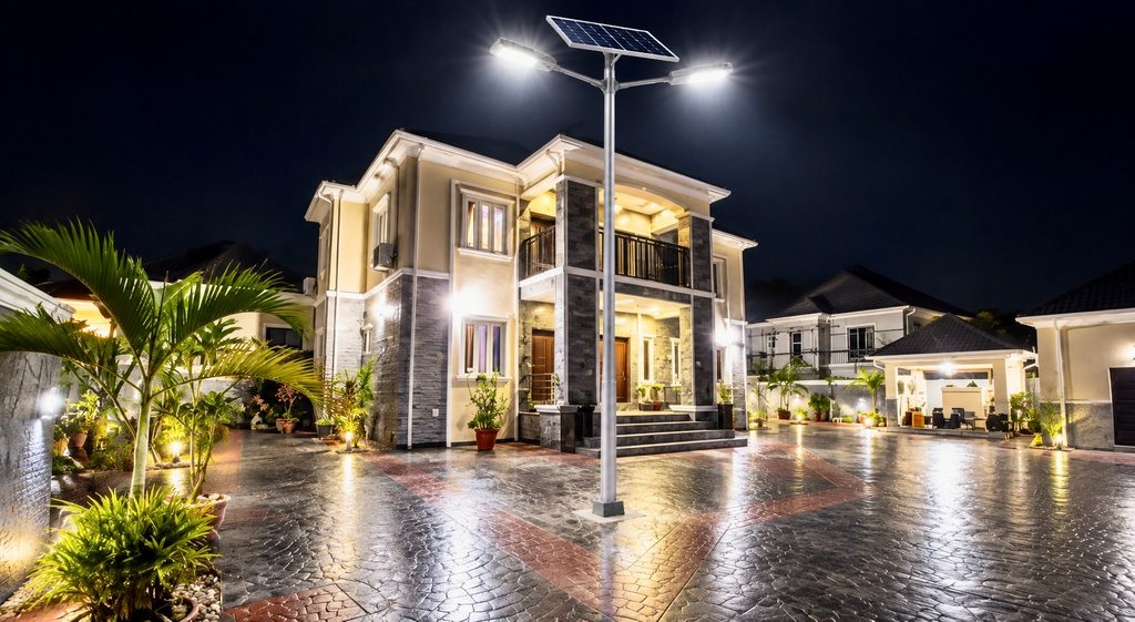 Solar security lights illuminating a Nigerian home compound at night